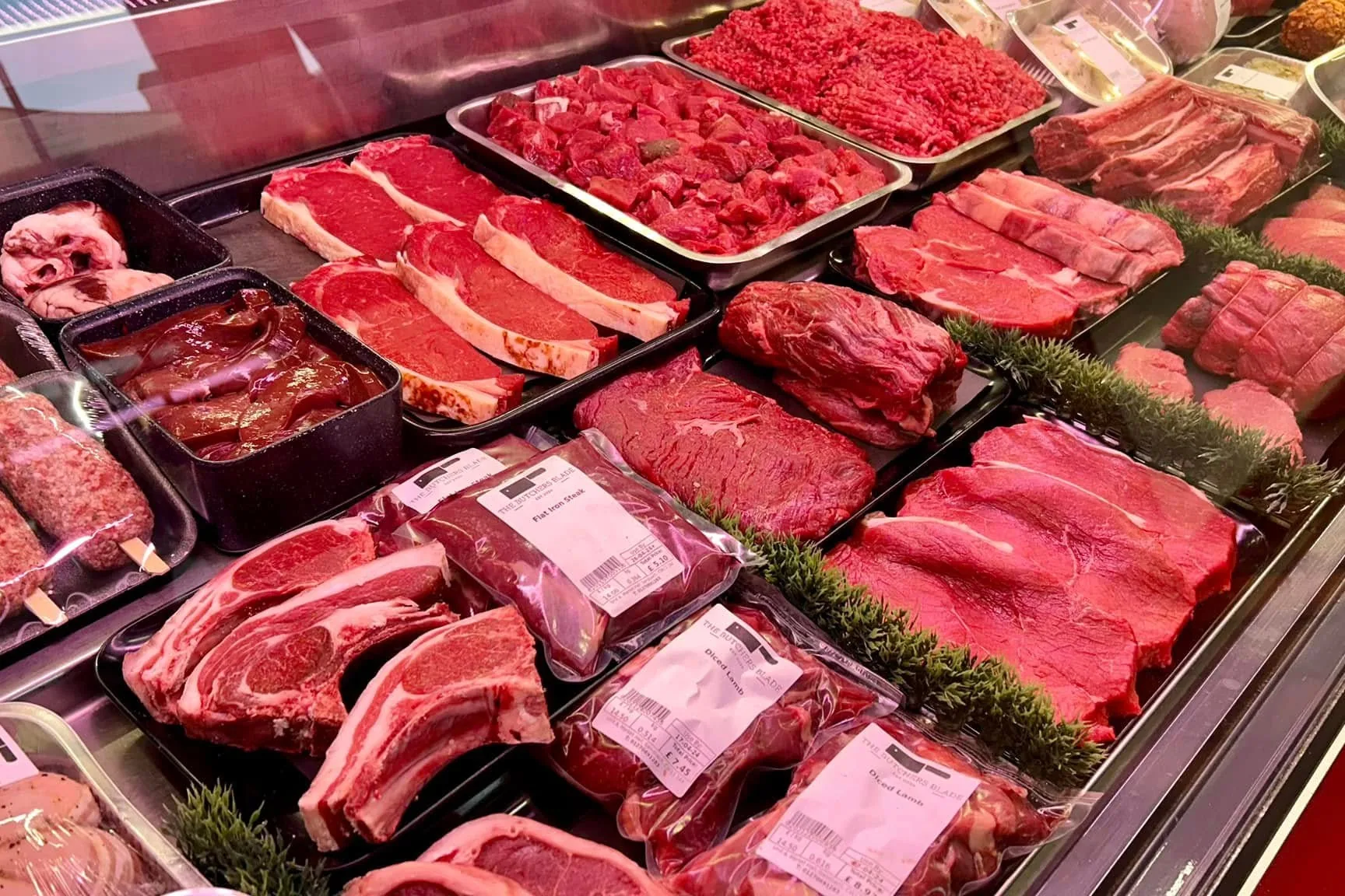 Meat cuts and prepared dishes displayed at The Butchers Blade counter in Sandbach Market Hall