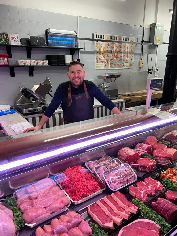 Lee standing behind his meat counter at The Butchers Blade in Sandbach Market Hall